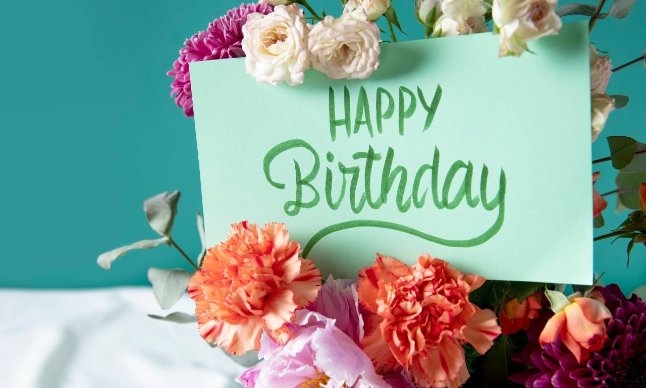 Birthday blessings filled with love and joy message card with flowers and warm light