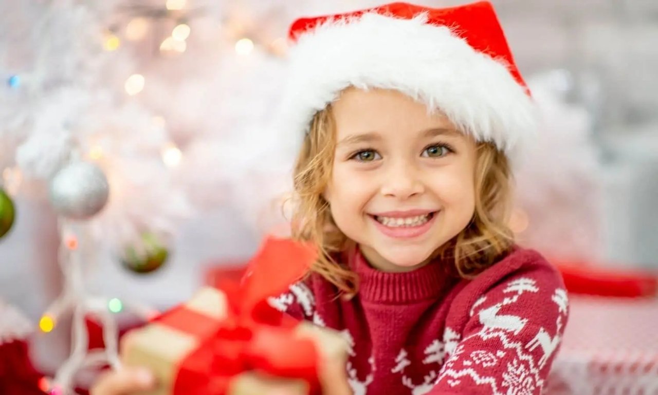 Smiling children opening faith-centered Christmas gifts near a decorated Christmas tree, including children's Bibles, prayer journals, and meaningful Christian presents celebrating the true spirit of Christmas.