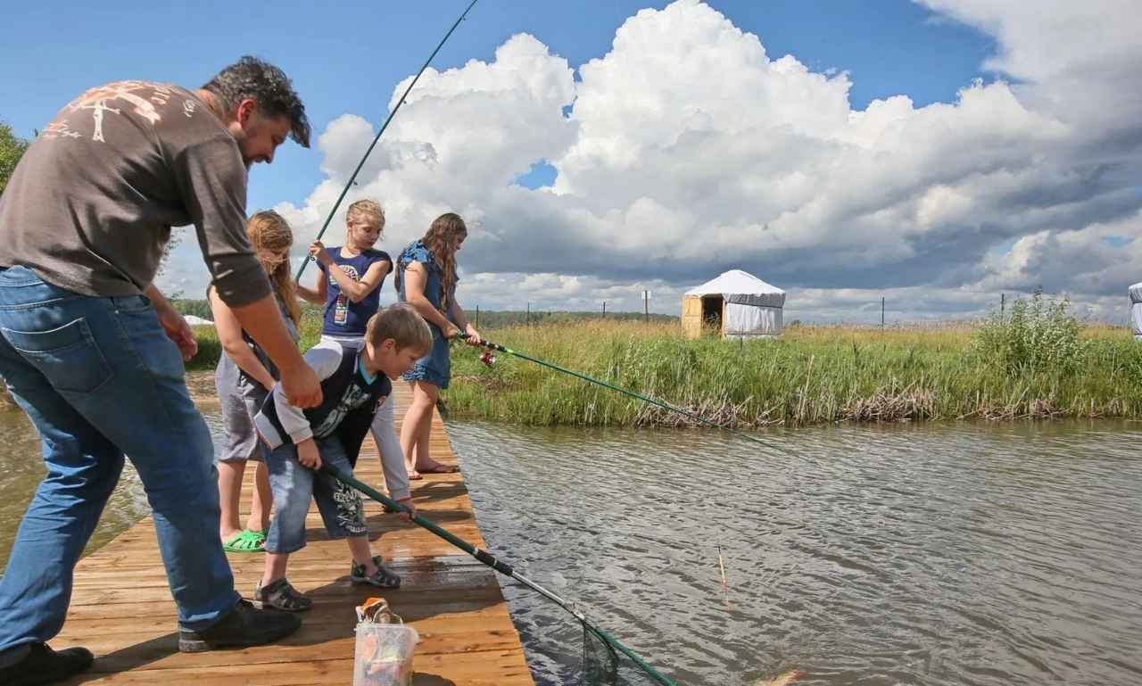 Happy anglers celebrating a fishing festival by a lake with fishing rods, laughter, and funny fishing festival blessings, quotes, wishes, and prayers promoting joy, faith, friendship, and community spirit.